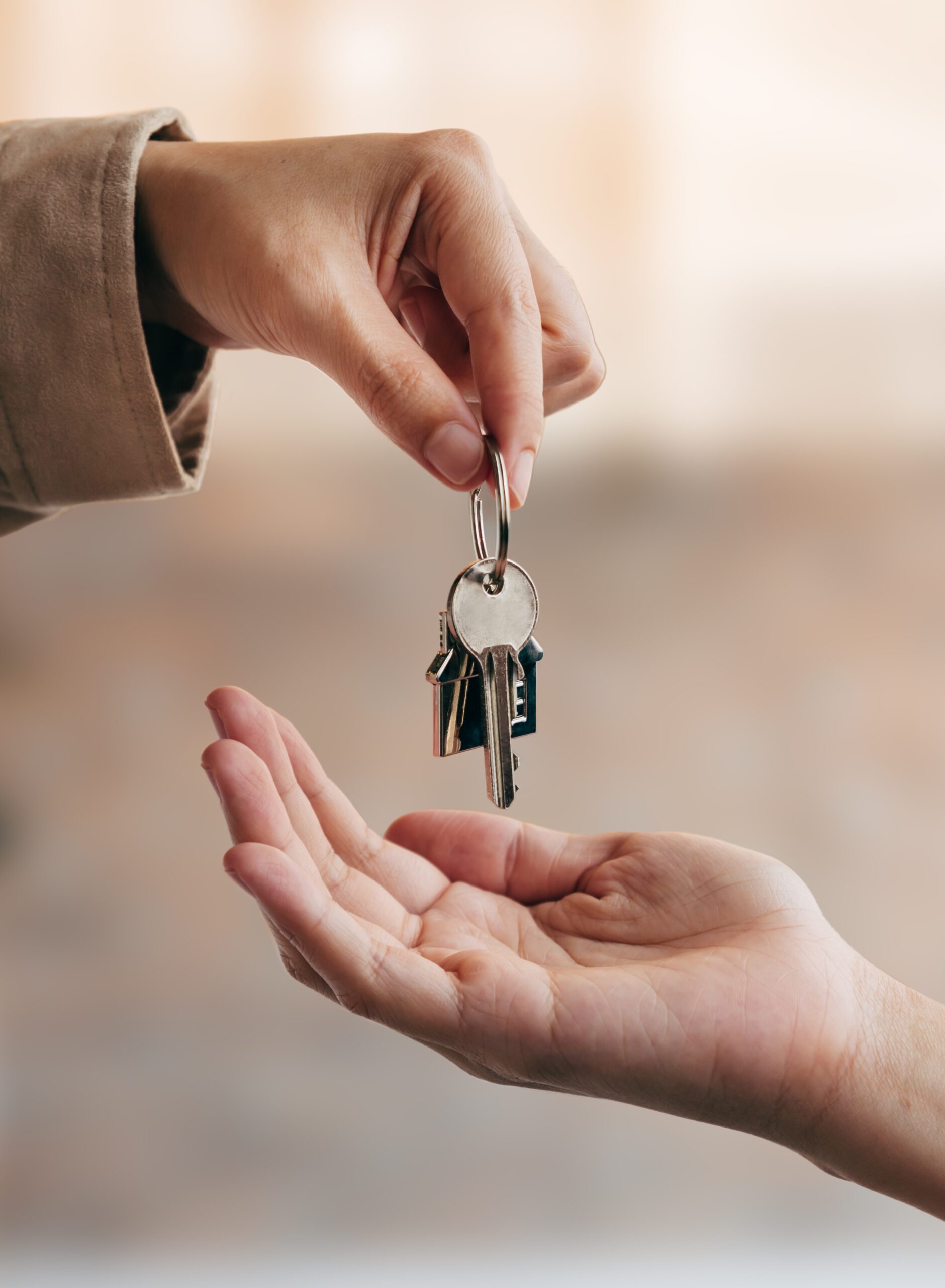 Young woman received house keys from real estate agent.